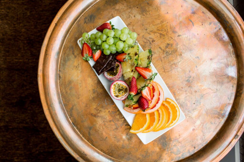 Fruit platter on table in boutique room at Varbergs Stadshotell