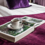 Coffee cup and book in Boutique Garden hotel room