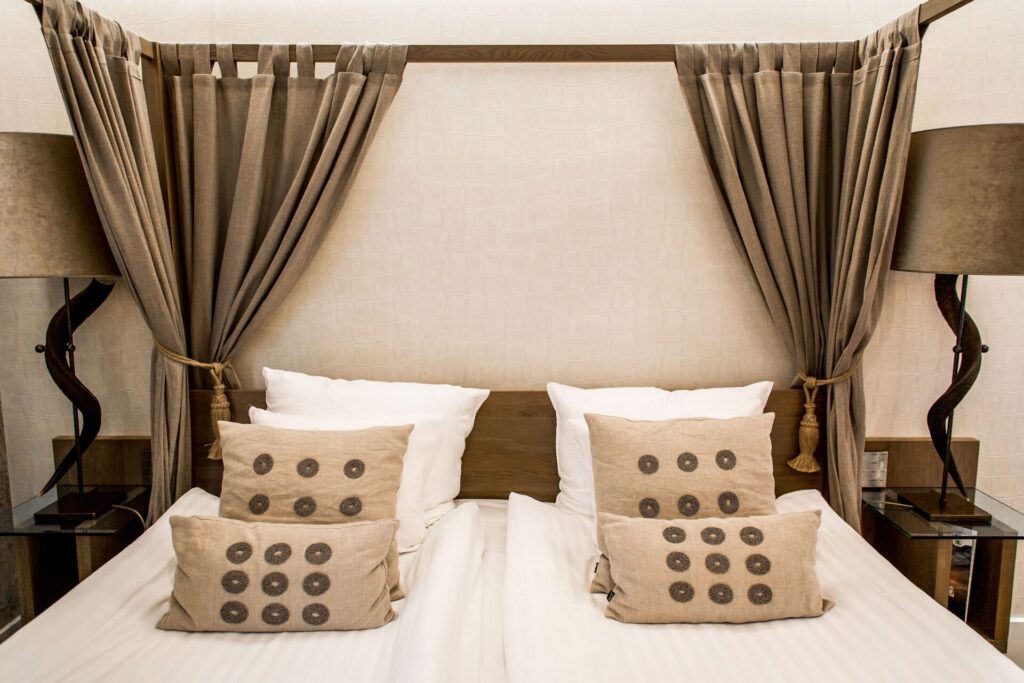 Bed in Boutique Kolonial hotel room at Varbergs Stadshotell